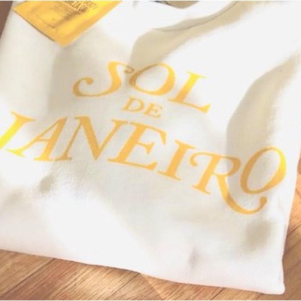 Sol de Janeiro Cream Sweatshirt with Yellow Logo.  Size M.  New without tag.